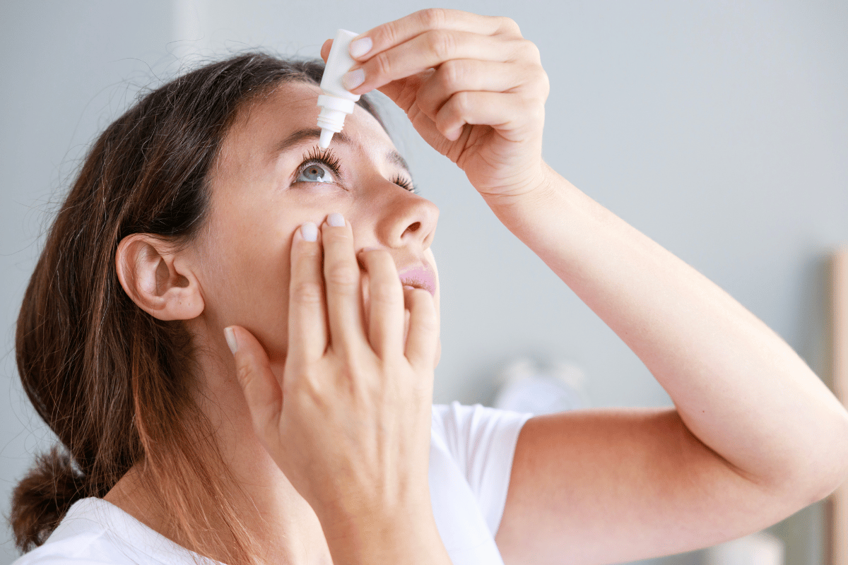 close-up of a woman putting eye drops in her eye